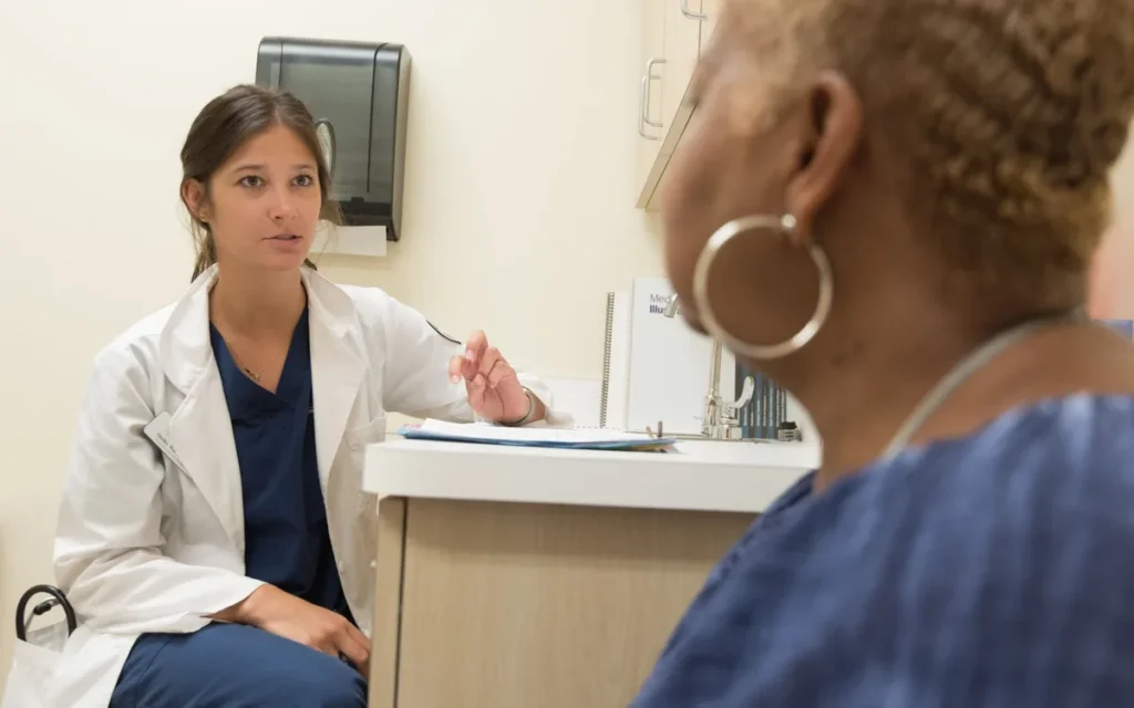 Clinician and patient discussing a weekly tirzepatide dosing check-in