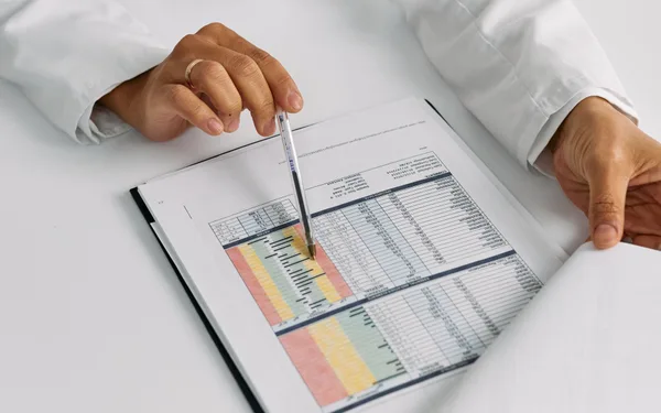Clinician reviewing lab results on a chart, representing trial data for semaglutide and tirzepatide